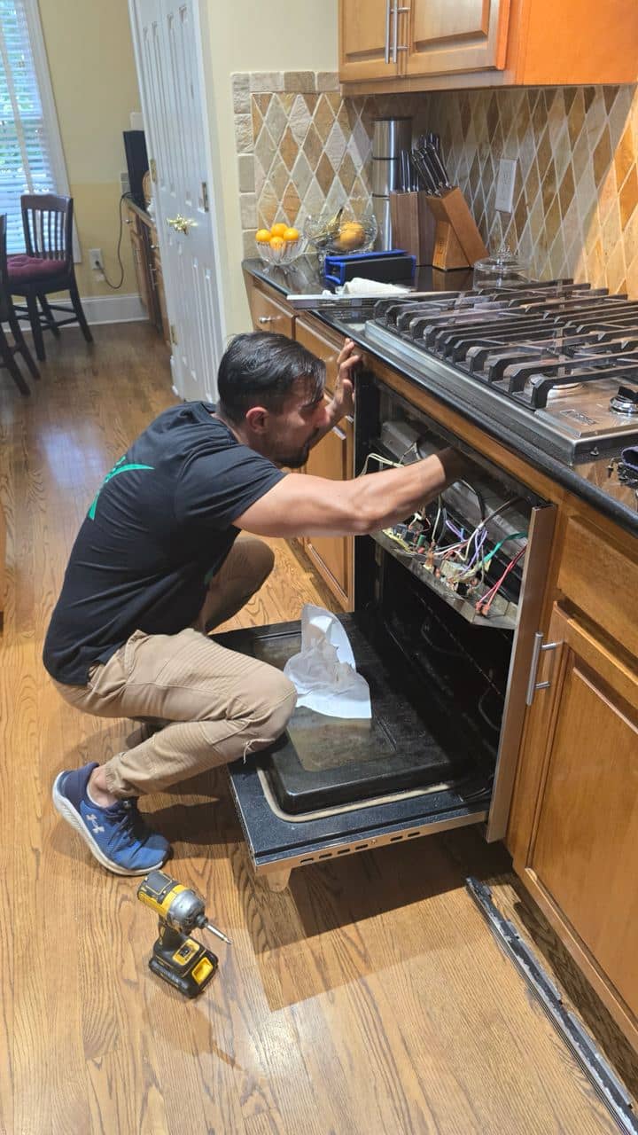 OK Appliance Repair technician working on an oven