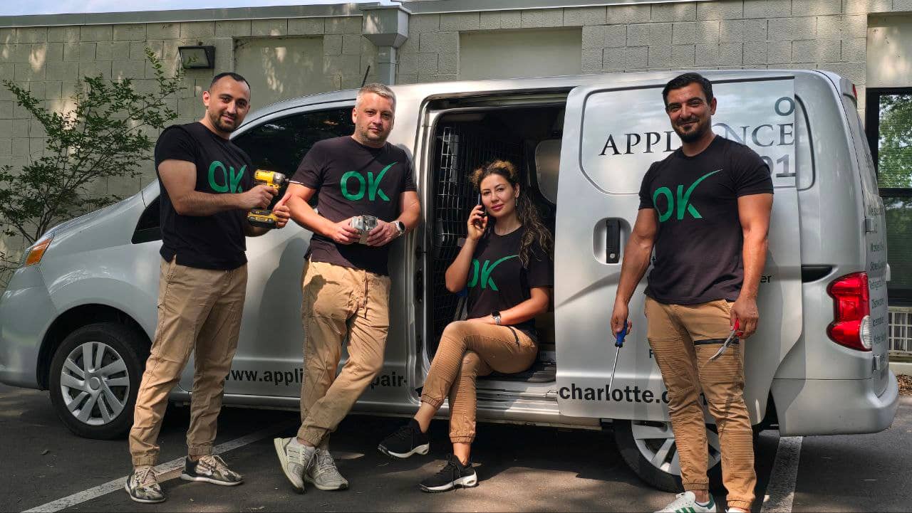 The OK Appliance Repair team beside their branded service van