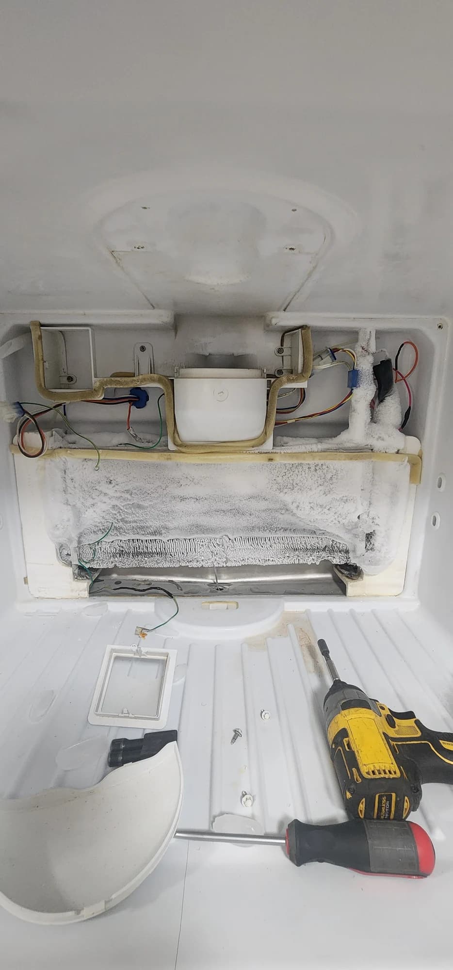 Frost-covered evaporator from our GE refrigerator repair in Charlotte